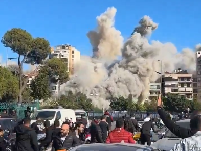 Video footage captures an Israeli missile striking a residential building in Beirut, reducing it to rubble.